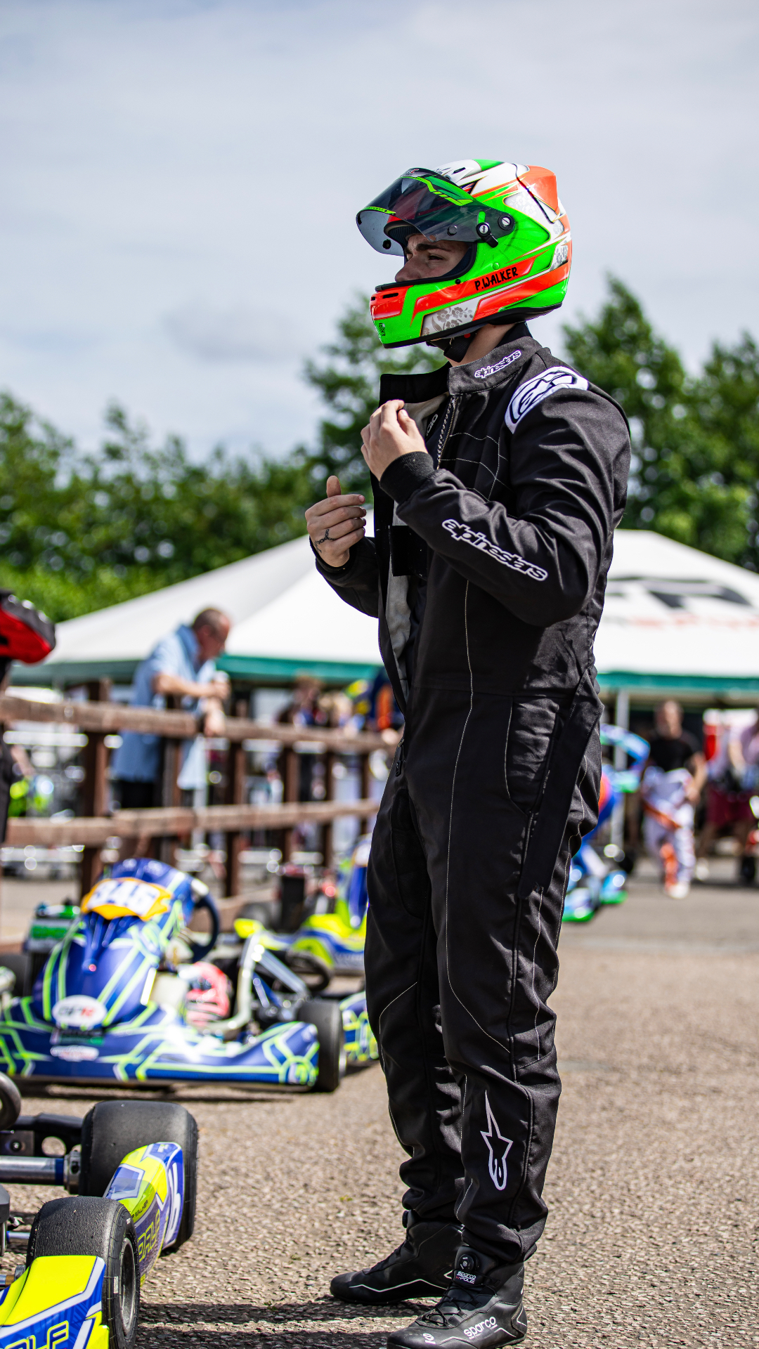 Presley Walker in race suit and helmet